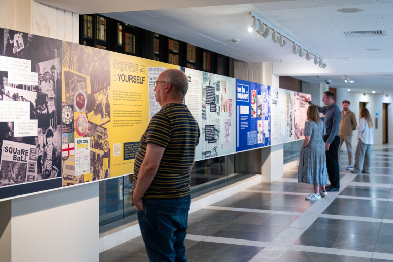 People looking at exhibition panels
