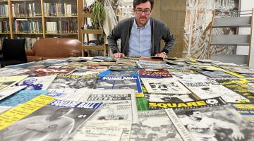 Librarian Antony Ramm overlooks a table full of football fanzines